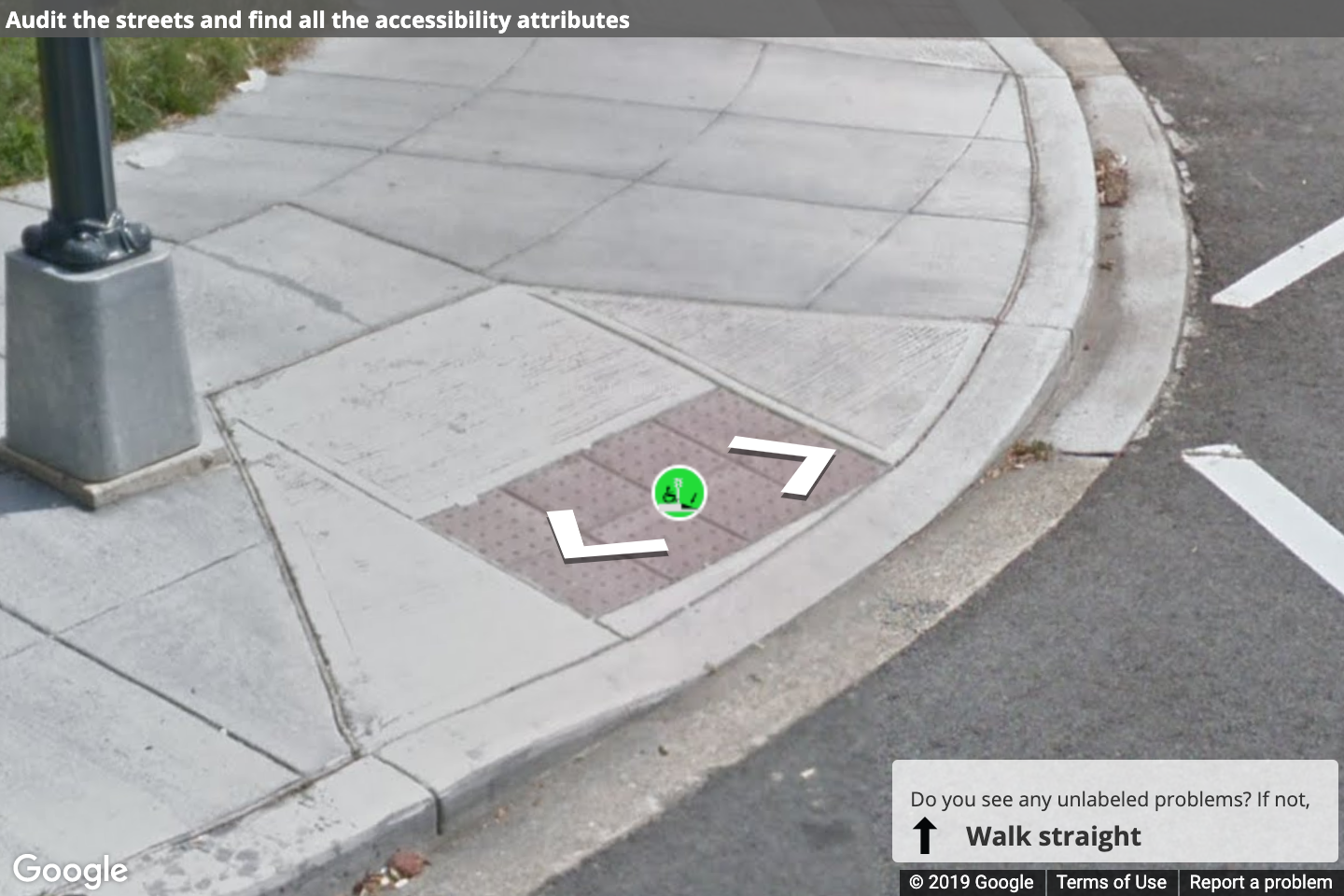 A label correctly placed at the center of a curb ramp A Street View image of a curb ramp with a label